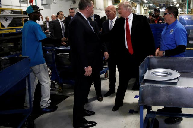Donald Trump  greets workers as he tours a Carrier factory with United Technologies CEO Greg Hayes in Indianapolis, Indiana, on 1 December 2016