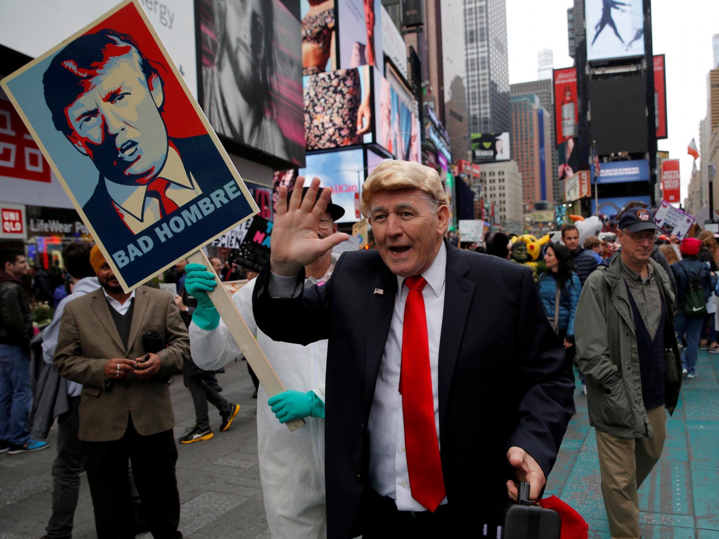 A person dressed as US President Donald Trump walks among protesters during the Earth Day 'March For Science NYC' demonstration in Manhattan, New York