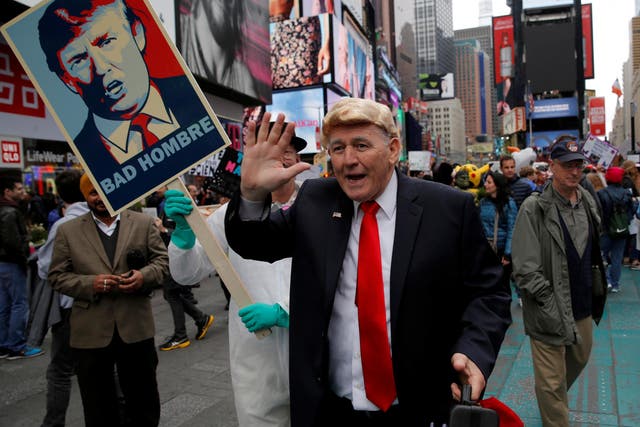 A person dressed as US President Donald Trump walks among protesters during the Earth Day 'March For Science NYC' demonstration in Manhattan, New York