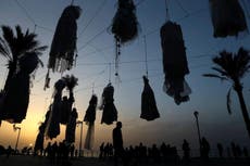 Women hang wedding dresses from Beirut seafront in rape law protest