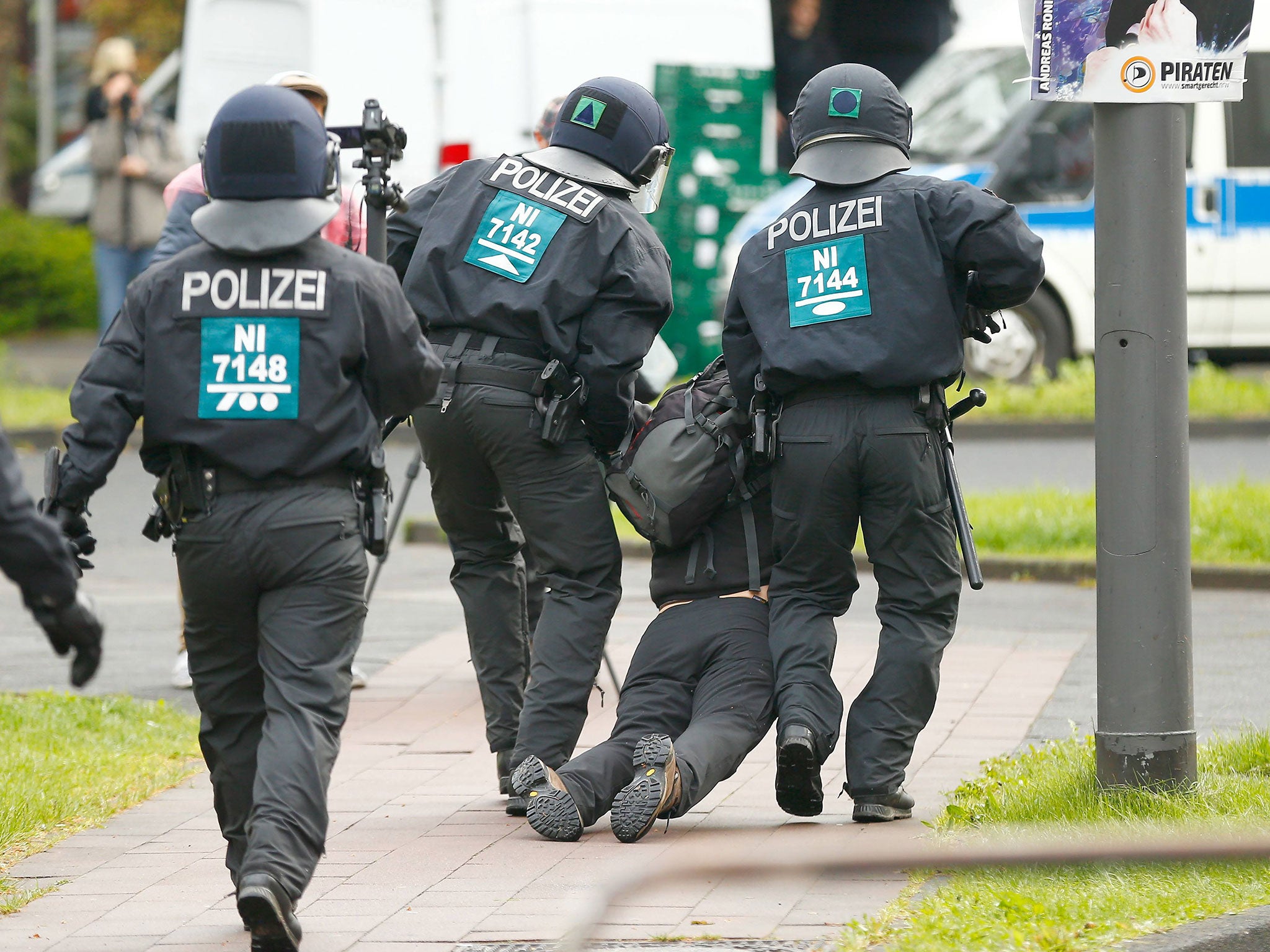 Police arrest an activist during a demonstration against anti-immigration party the Alternative for Germany (AfD) before the party's conference in Cologne on 22 April