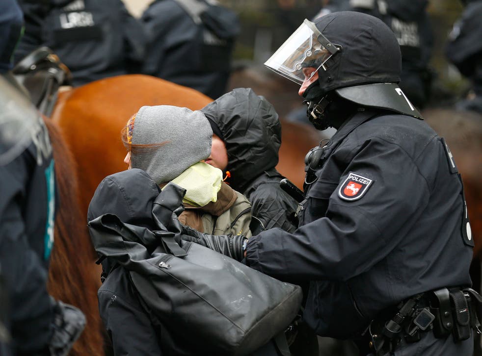 Police arrest activists during a demonstration against anti-immigration party rgw Alternative for Germany (AfD) before its convention in Cologne on 22 April