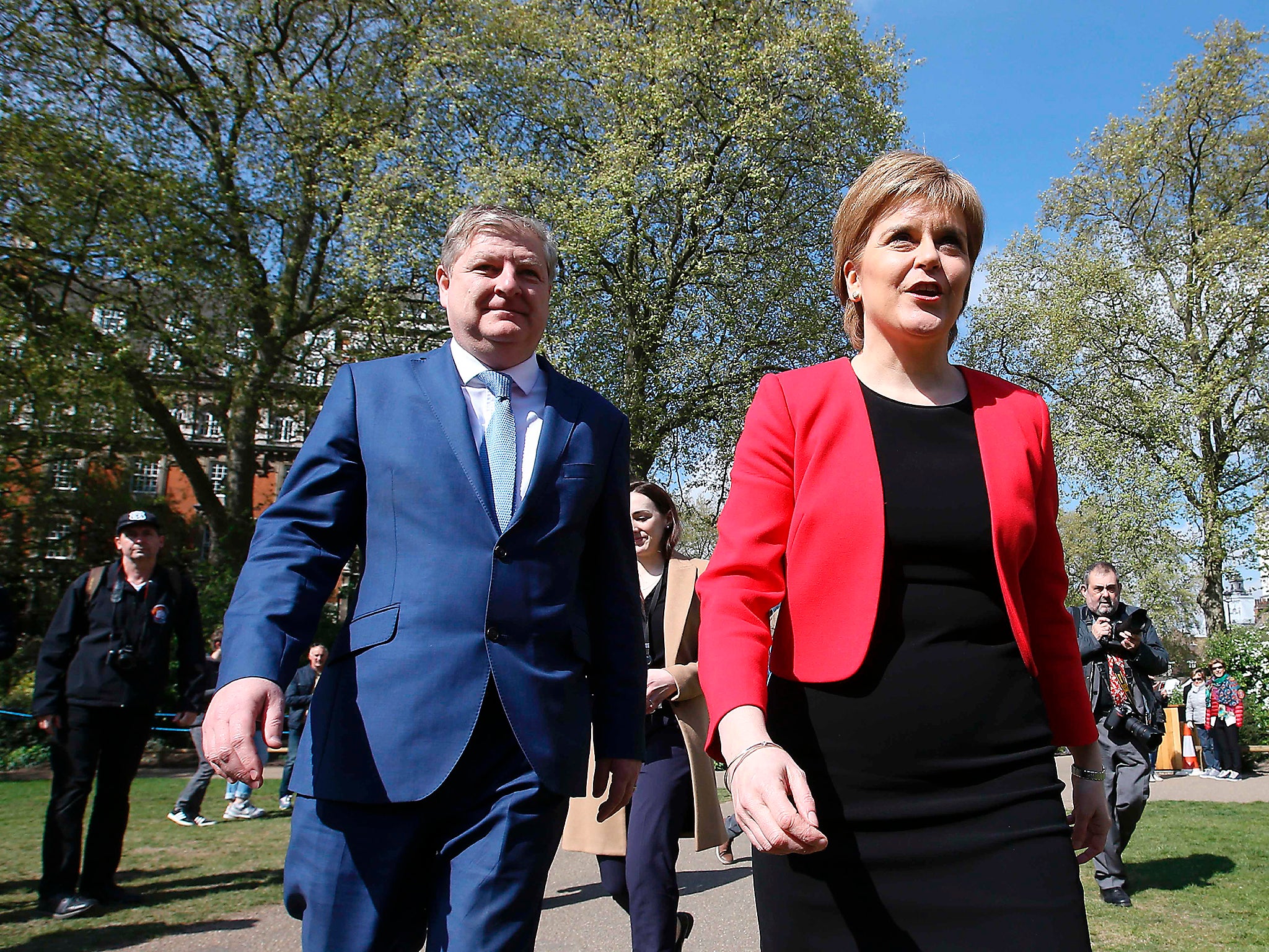 Scotland's First Minister and Scottish National Party leader Nicola Sturgeon walks with deputy leader and member of parliament Angus Robertson during a media facility outside the Houses of Parliament