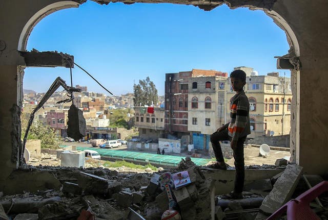A boy checks the damage following a mortar shell attack on the Yemen's flashpoint southern city of Taiz on 3 February, 2016