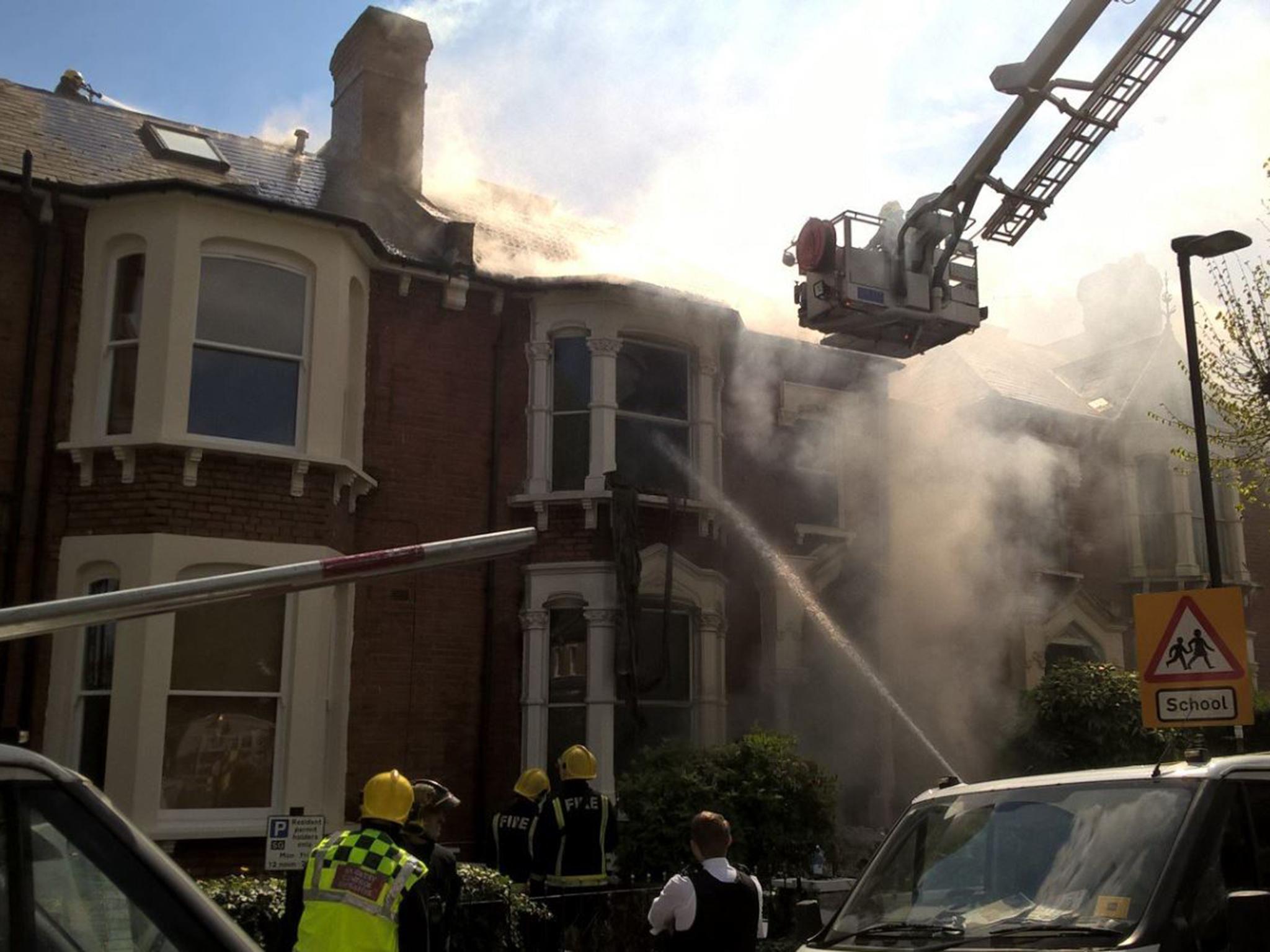 Firefighters outside a house in Stroud Green where an explosion took place on 19 April