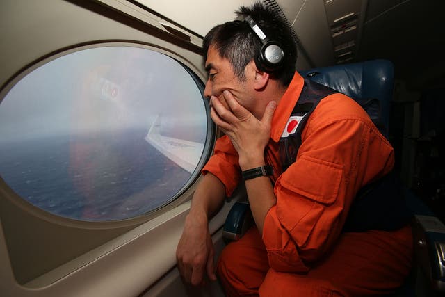 A member of the Japanese coastguard surveys the Indian Ocean in search that was called off in January