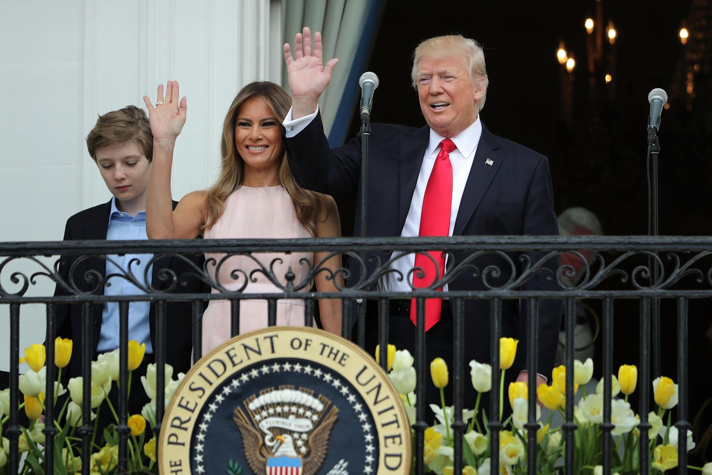 Picture: President Donald Trump and first lady Melania Trump wave to guests from the Truman Balcony with their son Barron Trump during the 139th Easter Egg Roll on the South Lawn of the White House April 17, 2017 in Washington, DC