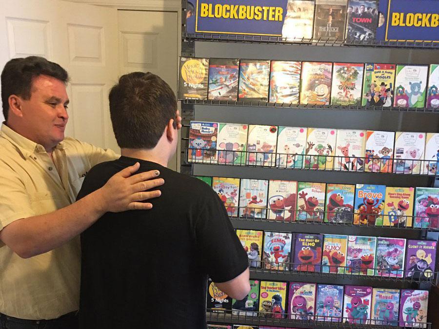 Hector's father shows his son the surprise new mini-Blockbuster store in their home