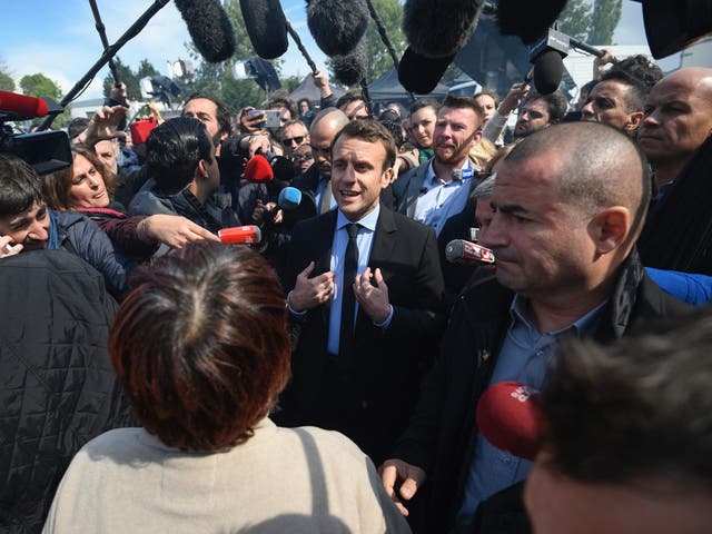 Emmanuel Macron speaks to journalists as he arrives at the Whirlpool factory, in Amiens