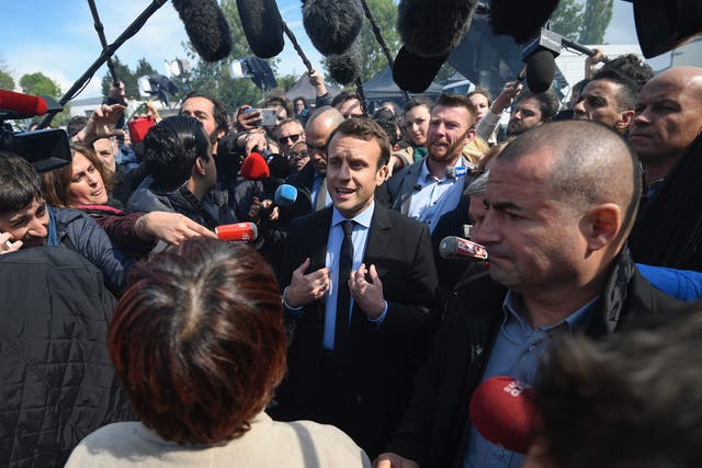 Emmanuel Macron speaks to journalists as he arrives at the Whirlpool factory, in Amiens