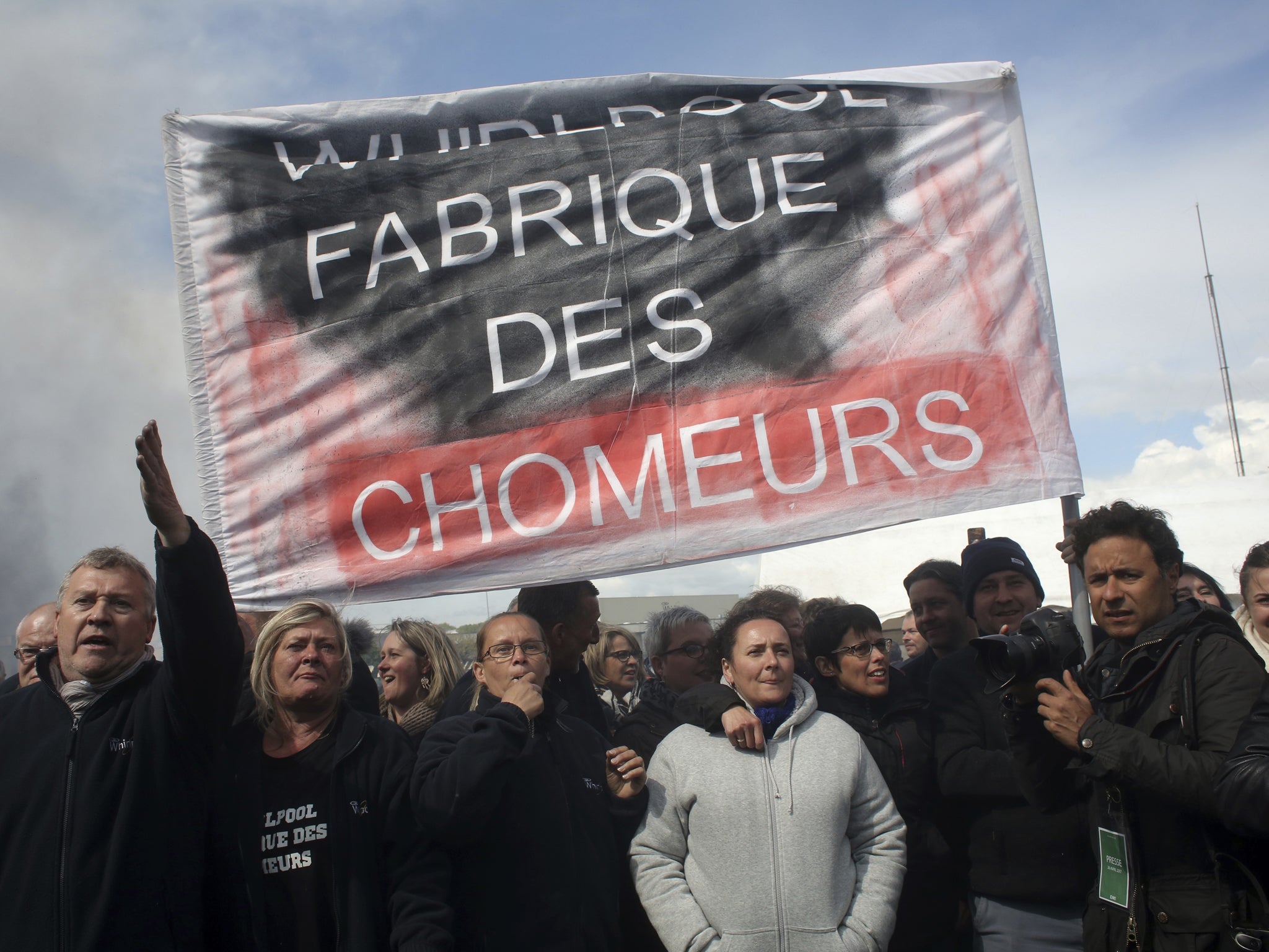 Workers demonstrate with a banner reading ‘Whirlpool makes jobless’ at the Whirlpool home appliance factory, in Amiens, northern France