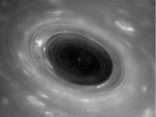 A huge hurricane sweeps across Saturn's surface in this raw photo from Cassini