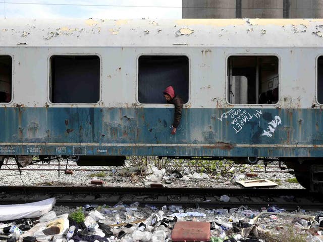 Habib, 22, from Algeria sits in an abandoned railway wagon used as a shelter by stranded migrants. Habib  arrived at the Greek island of Rhodes three months ago and he reached the mainland after hiding in a truck on a passenger ferry to Athens