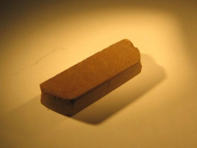 A brick made of simulated Martian soil. A small amount of pressure can turn it into a material with the strength of steel-reinforced concrete