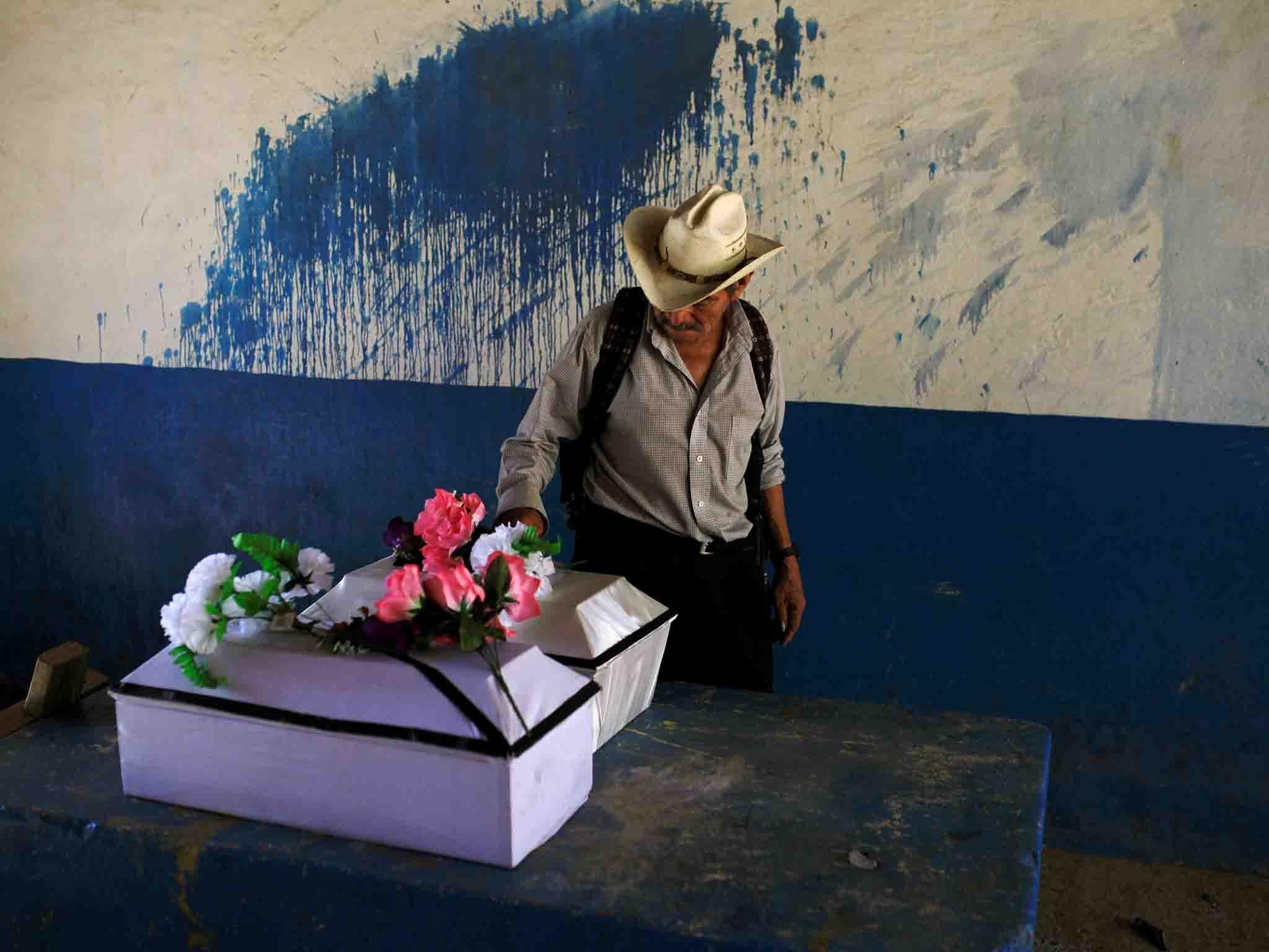 The remains of Petrona Chavarria and Vilma Ramos, who died in the El Mozote massacre, prior to their burial in the town of Jocoatique, in El Salvador