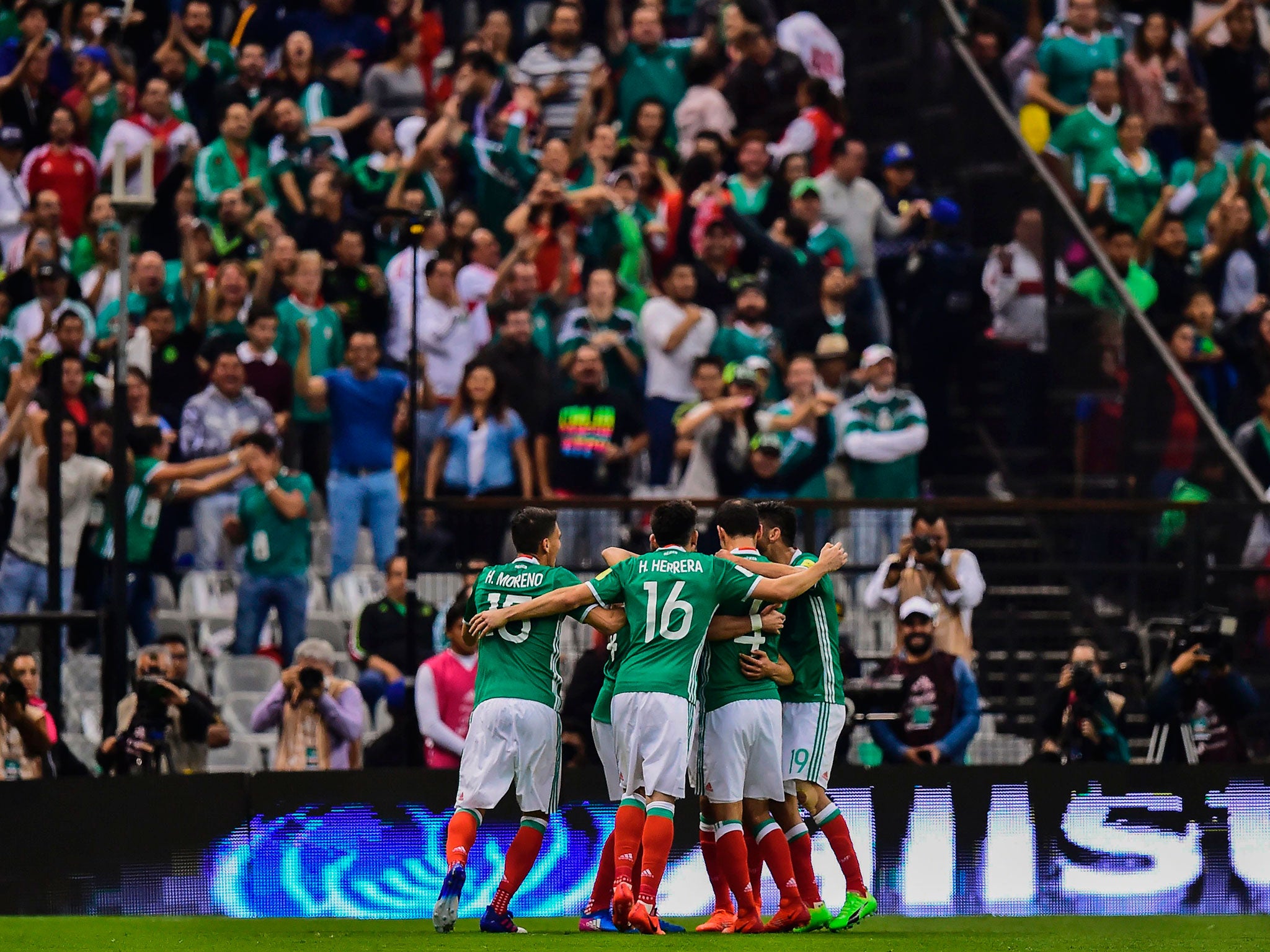 Mexican players celebrate a goal against Costa Rica during their 2018 FIFA World Cup qualifier football match in Mexico City on March 24, 2017