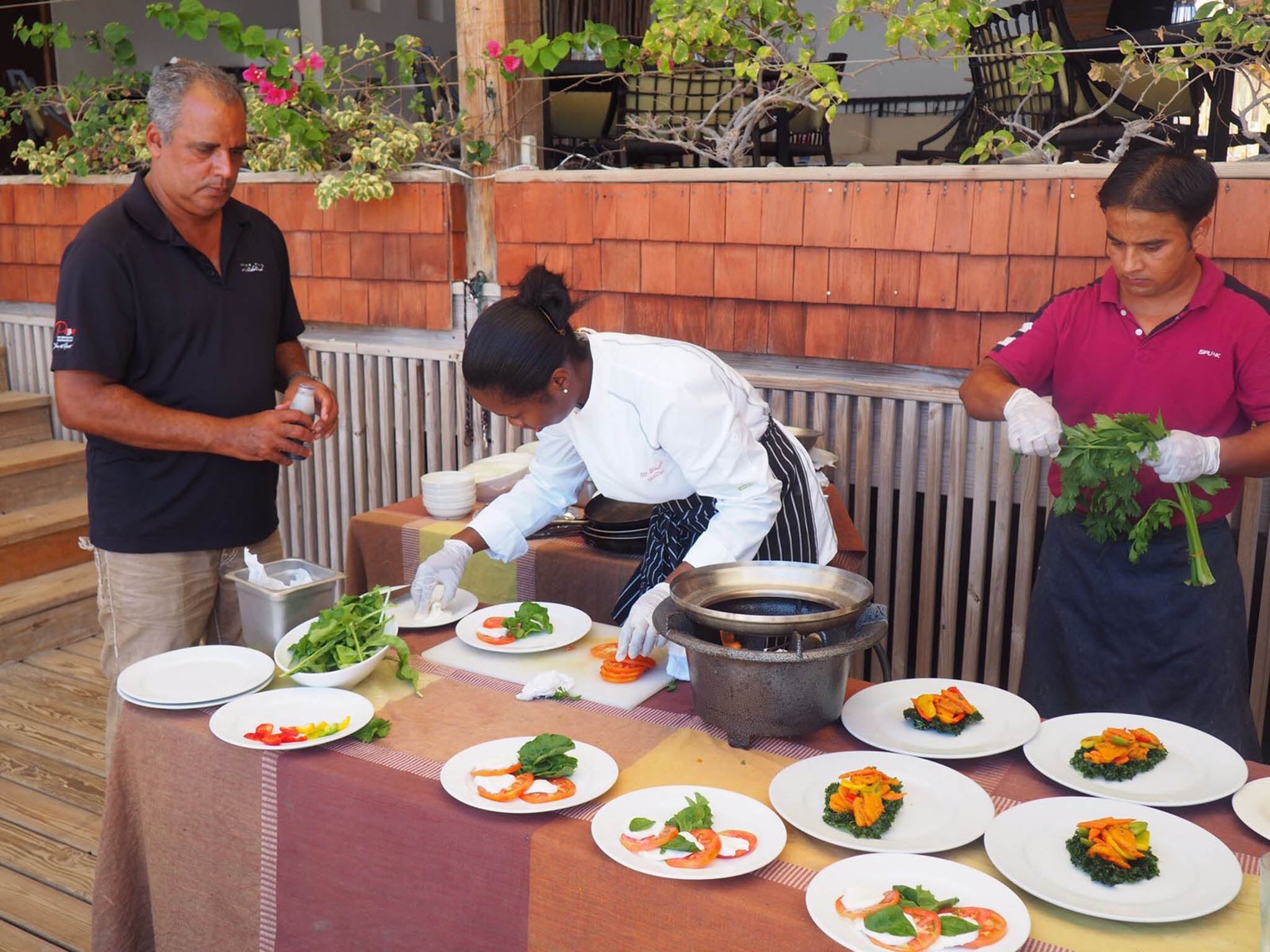 Roger and his staff plating up a tomato salad at The Spice Mill