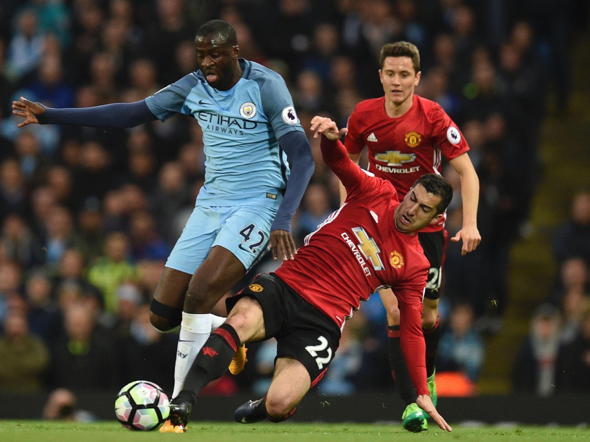 Toure attempts to get away from Mkhitaryan