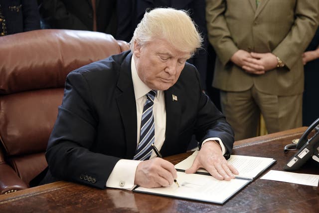 U.S. President Donald Trump signs a Memorandum on Aluminum Imports and Threats to National Security in the Oval Office