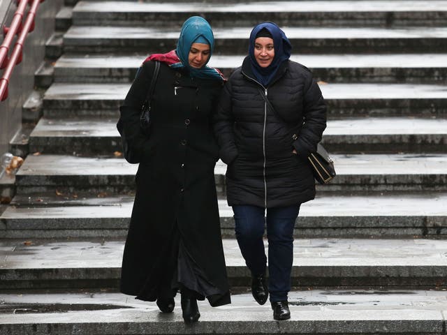 Women wearing headscarves walk on the street on December 1, 2016 in Vienna, Austria.