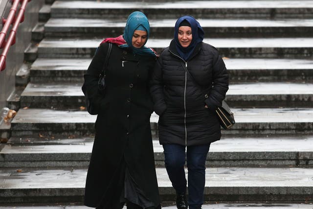 Women wearing headscarves walk on the street on December 1, 2016 in Vienna, Austria.