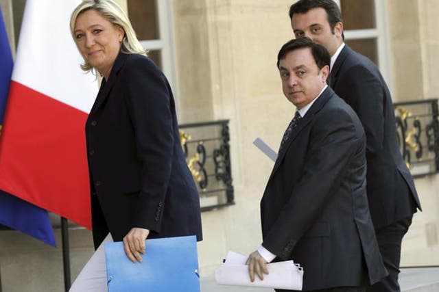 Marine Le Pen arrives at the Elysee Palace in Paris with National Front Vice-Presidents Jean-Francois Jalkh (centre) and Florian Philippot