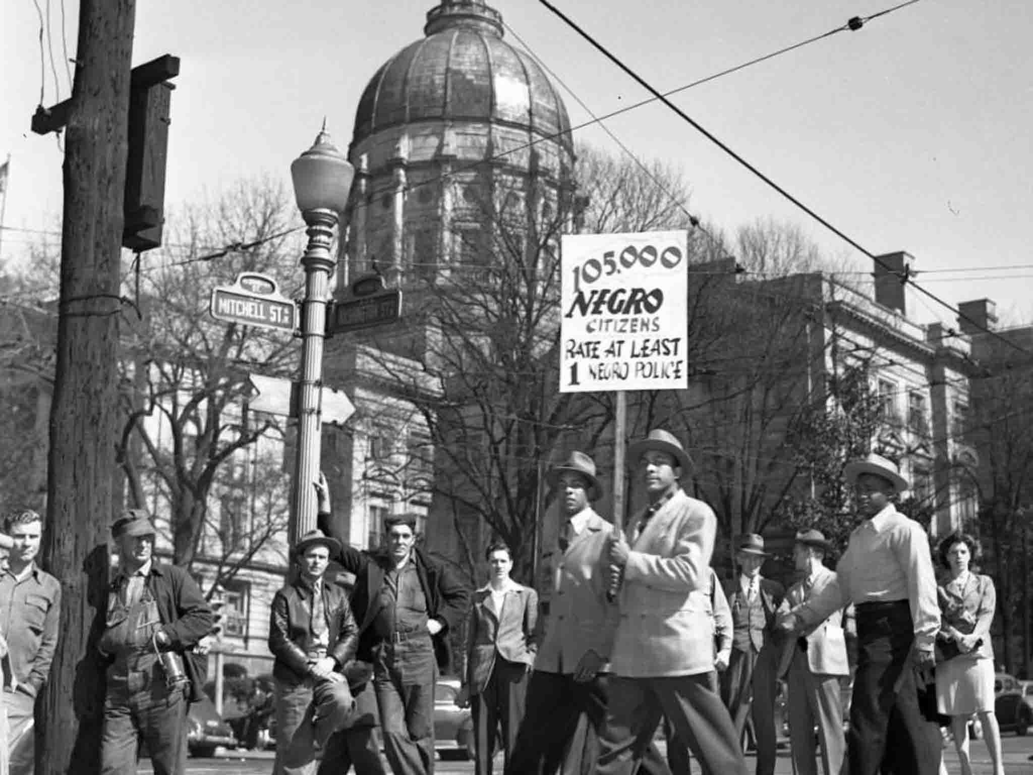 Black people march outside the Georgia State Capitol building in 1946, demanding representation on the police force