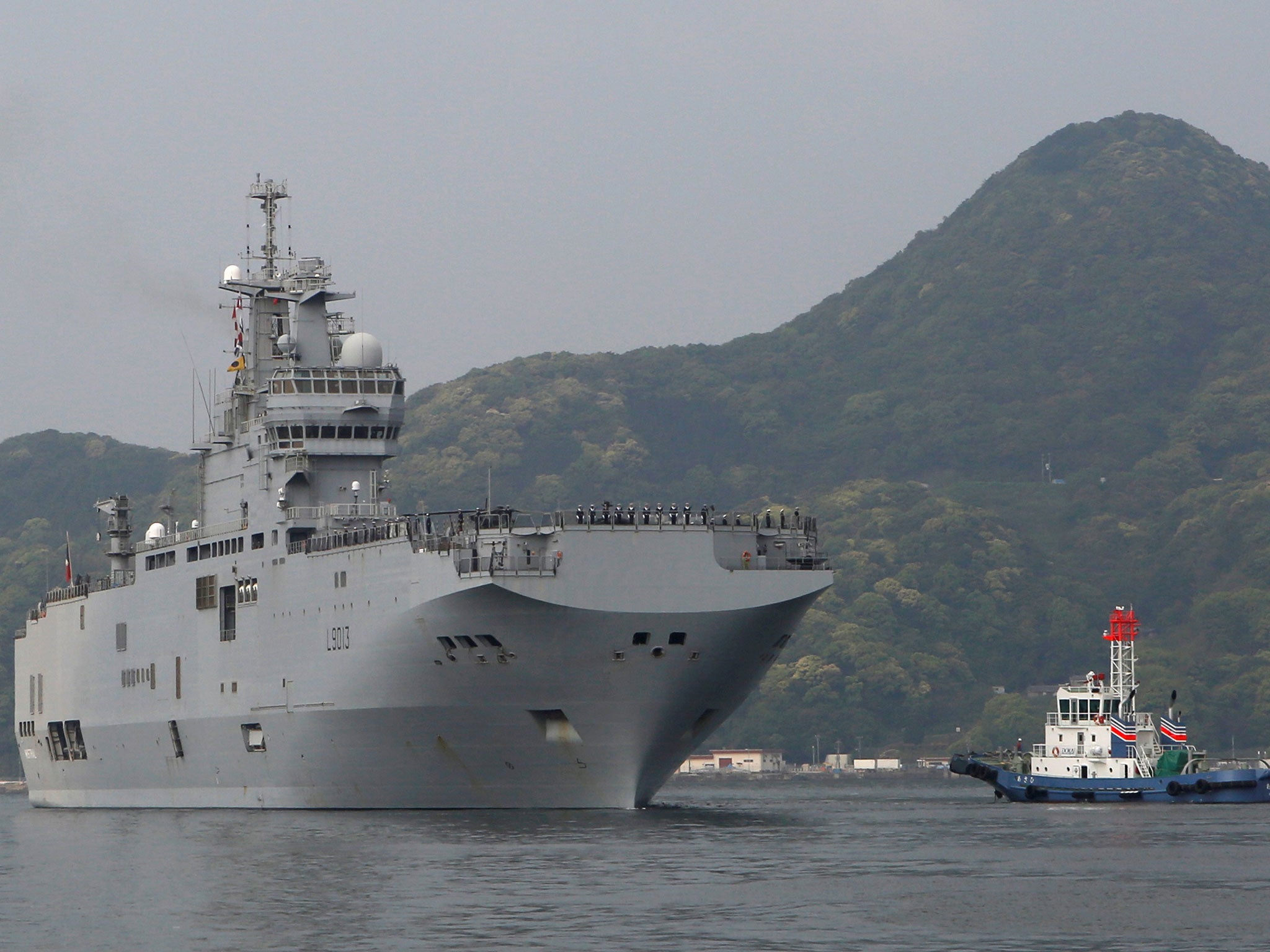 French amphibious assault ship Mistral (L) arrives at Japan Maritime Self-Defense Force's Sasebo naval base in Sasebo