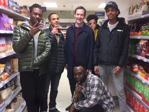 George Osborne poses with a group of youths in a supermarket