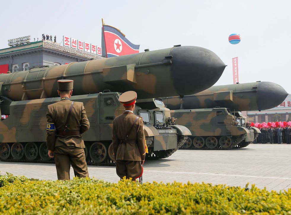 Missiles are driven past the stand with North Korean leader Kim Jong-un and other high ranking officials during a military parade in Pyongyang