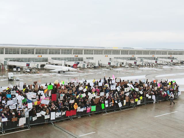 Hundreds of people rally against a temporary travel ban signed by US President Donald Trump in an executive order during a protest at Detroit Metropolitan airport in Romulus, Michigan