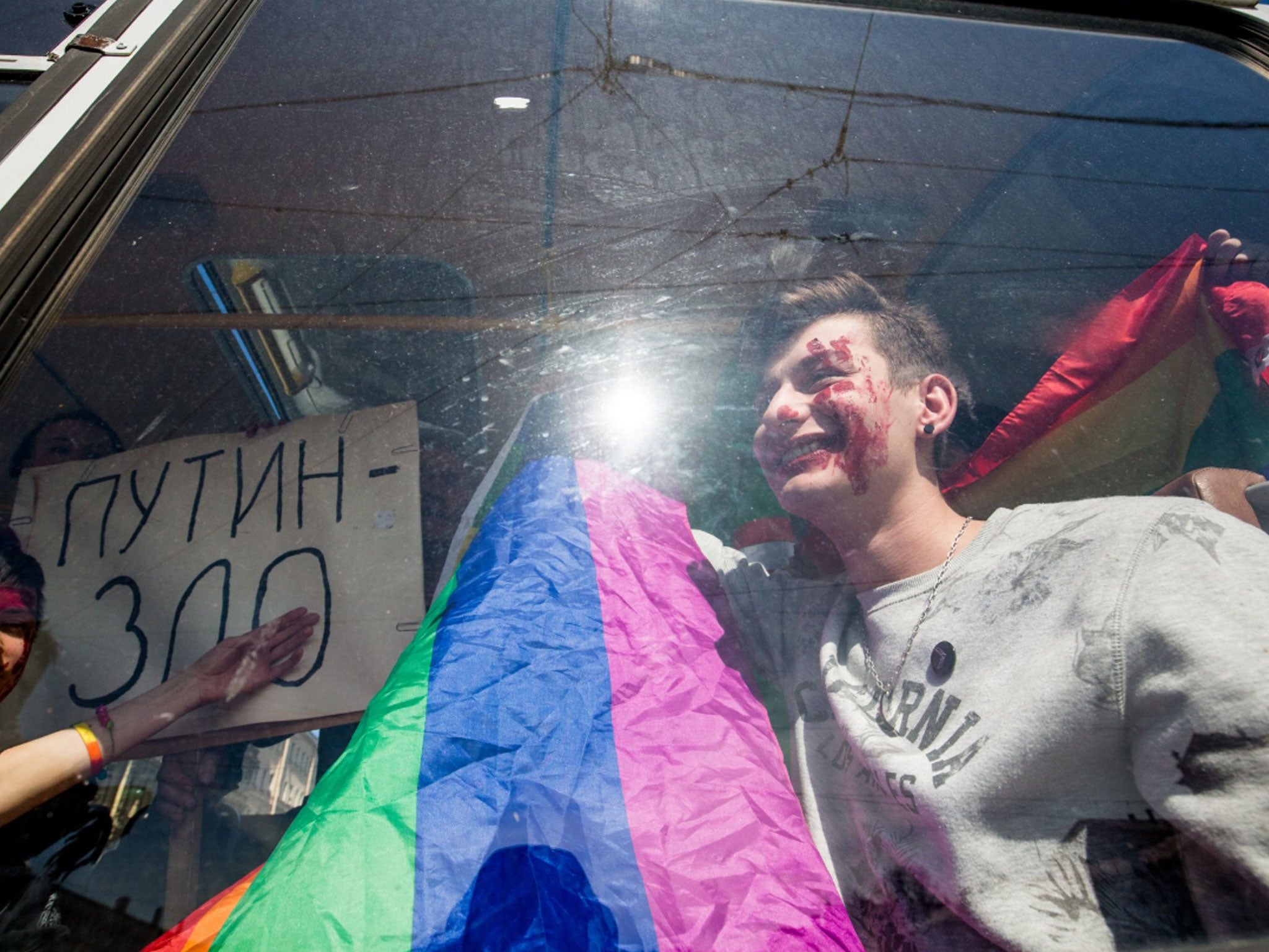 Gay-rights activists were bundled into two police vans during the protest