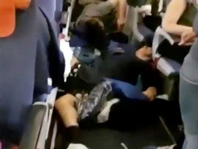 Passengers lying on floor and debris in plane cabin onboard an Aeroflot Boeing 777 flight from Moscow to Bangkok