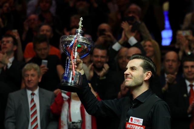 Mark Selby poses with the trophy after beating John Higgins