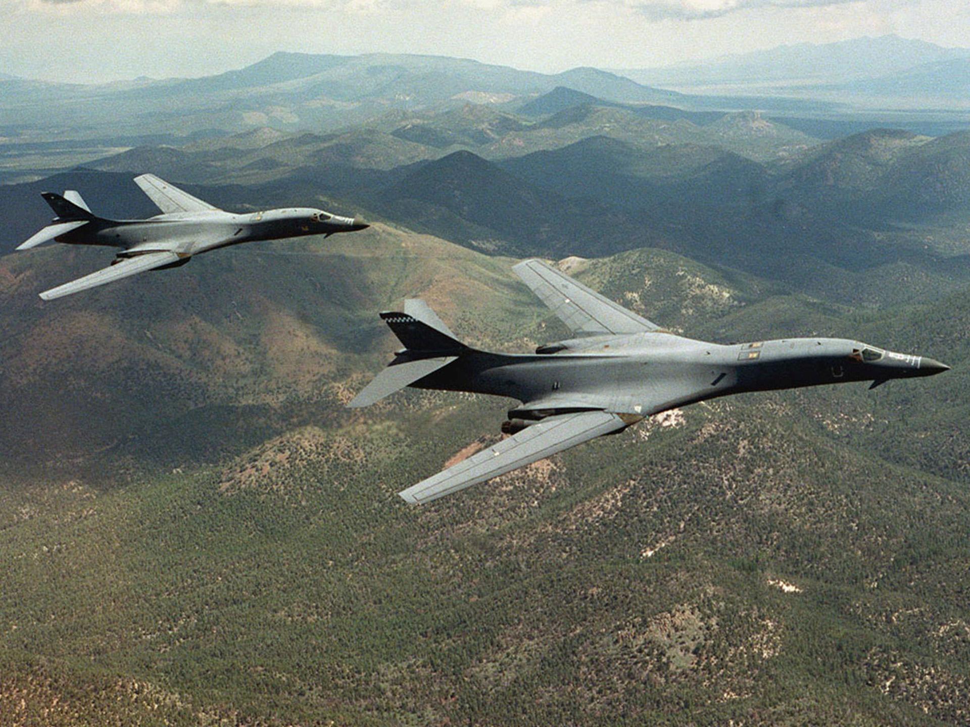 A pair of B-1B Lancer bombers soar over open country