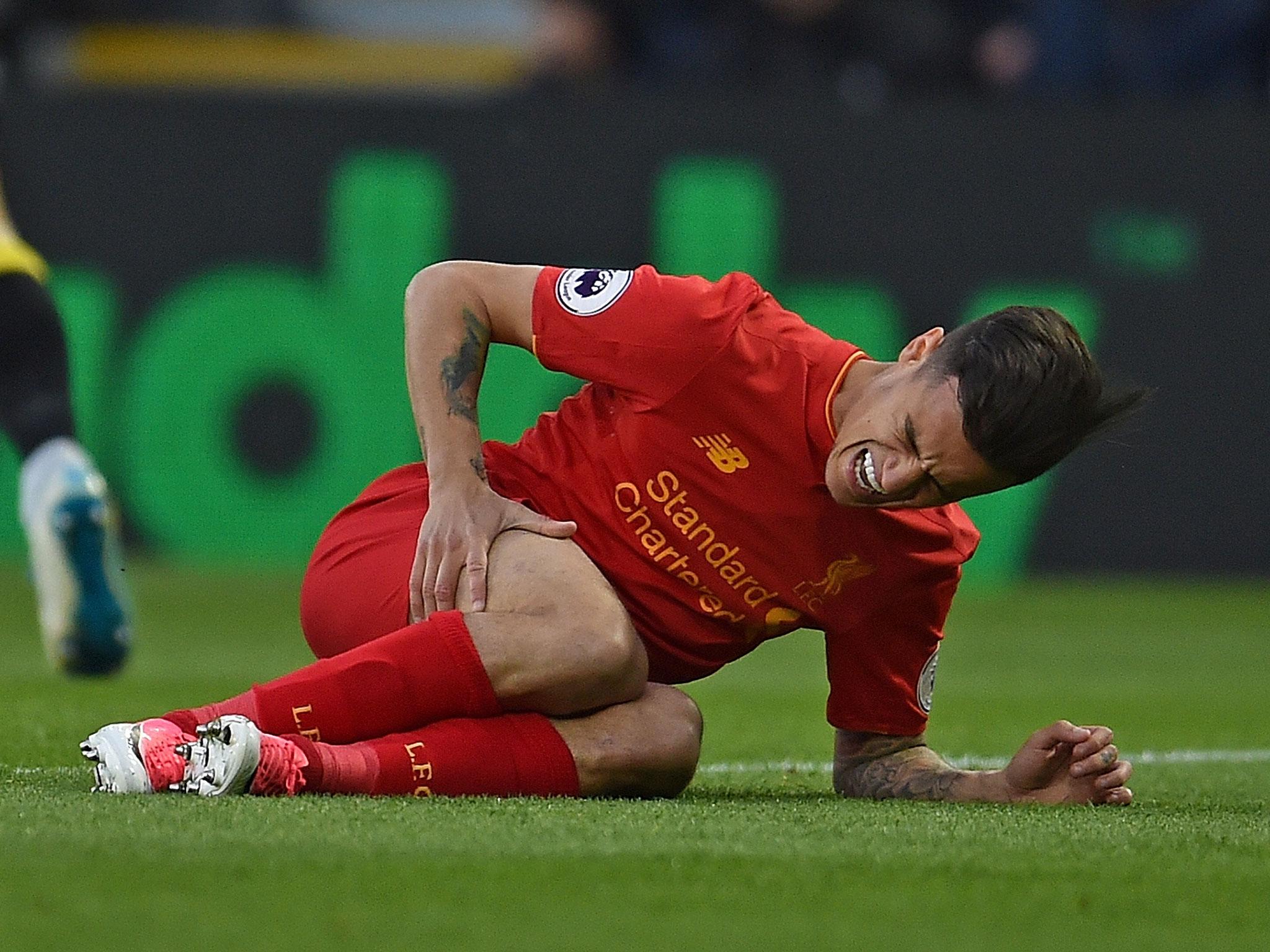 Phillipe Coutinho grabs his thigh in pain after suffering a dead leg in Liverpool's win over Watford