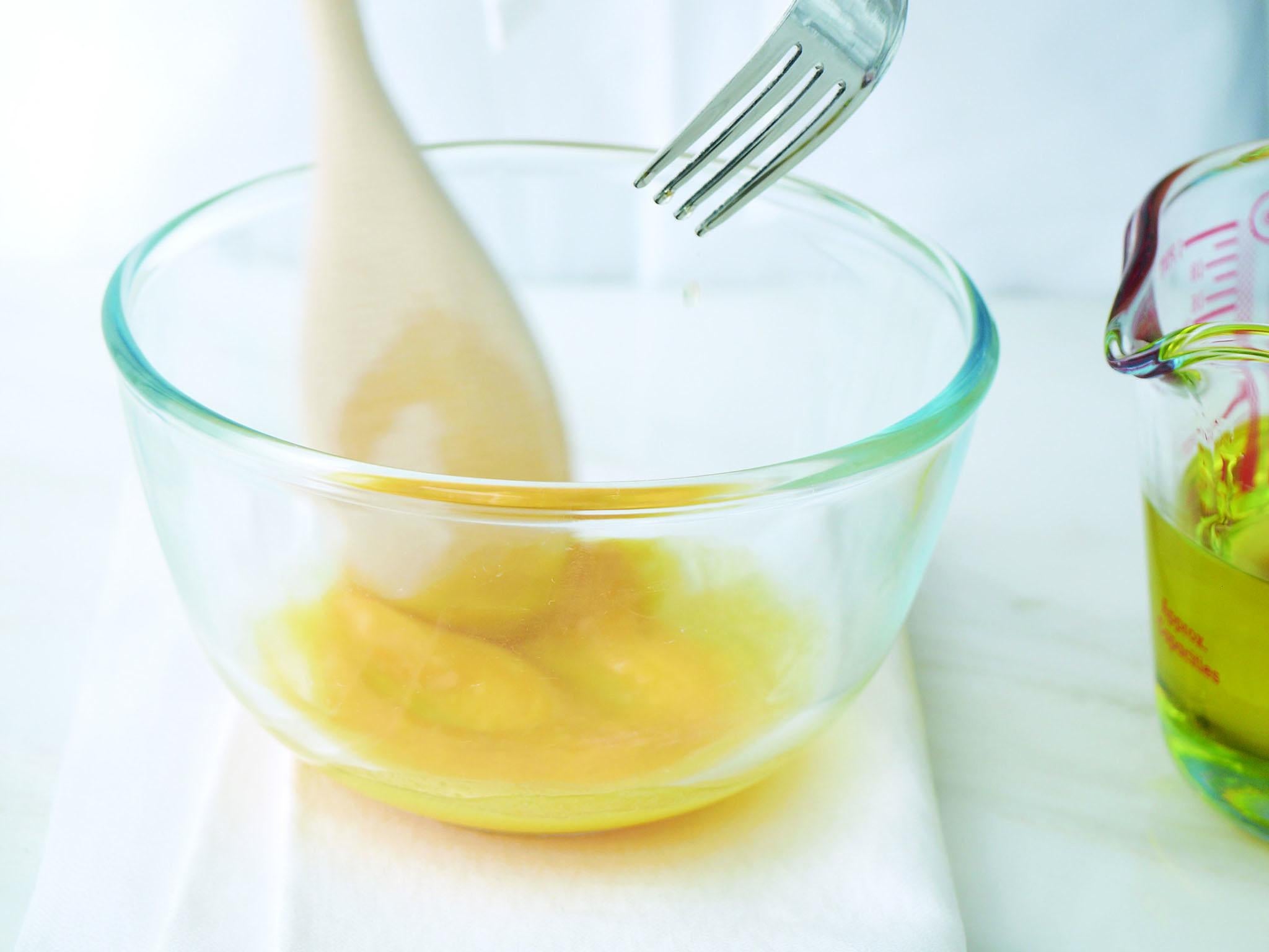 2. Dripping the oil on to the egg yolks from a fork, while stirring (Photos: Peter Cassidy)