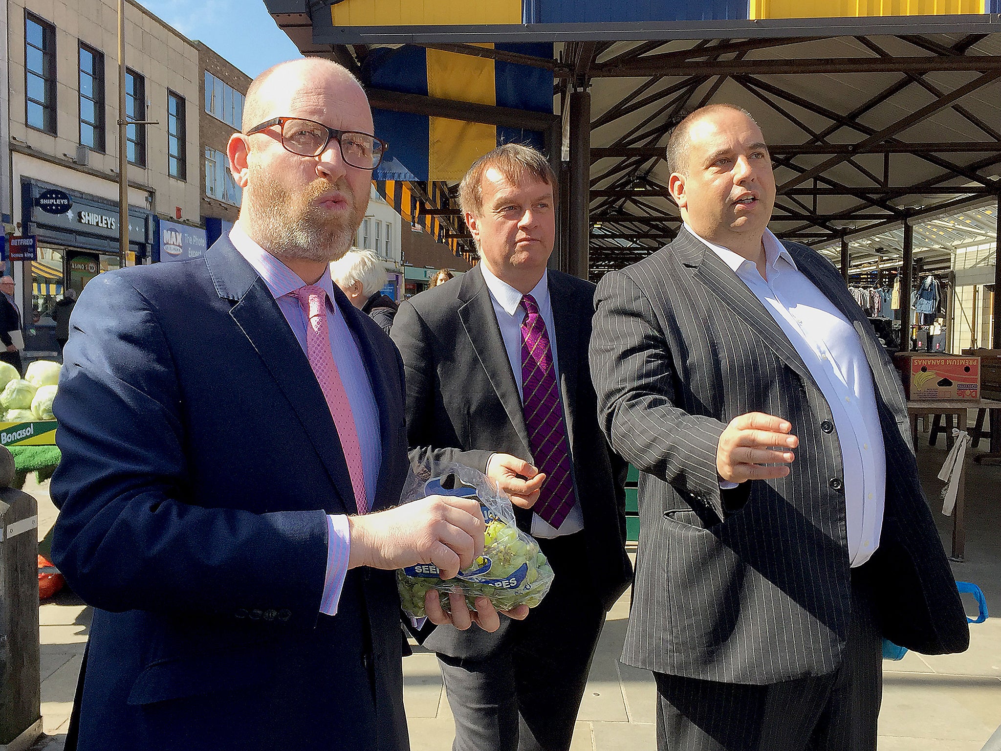 Ukip leader Paul Nuttall eats grapes during a walkabout in Dudley town centre in the West Midlands, with Ukip West Midlands MEP Bill Etheridge and Pete Durnell, West Midlands Metro Mayor candidate