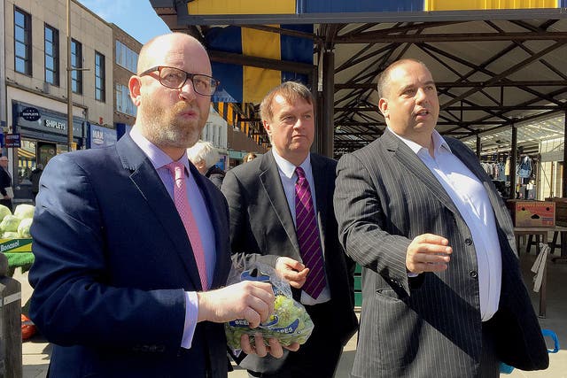 Ukip leader Paul Nuttall eats grapes during a walkabout in Dudley town centre in the West Midlands, with Ukip West Midlands MEP Bill Etheridge and Pete Durnell, West Midlands Metro Mayor candidate