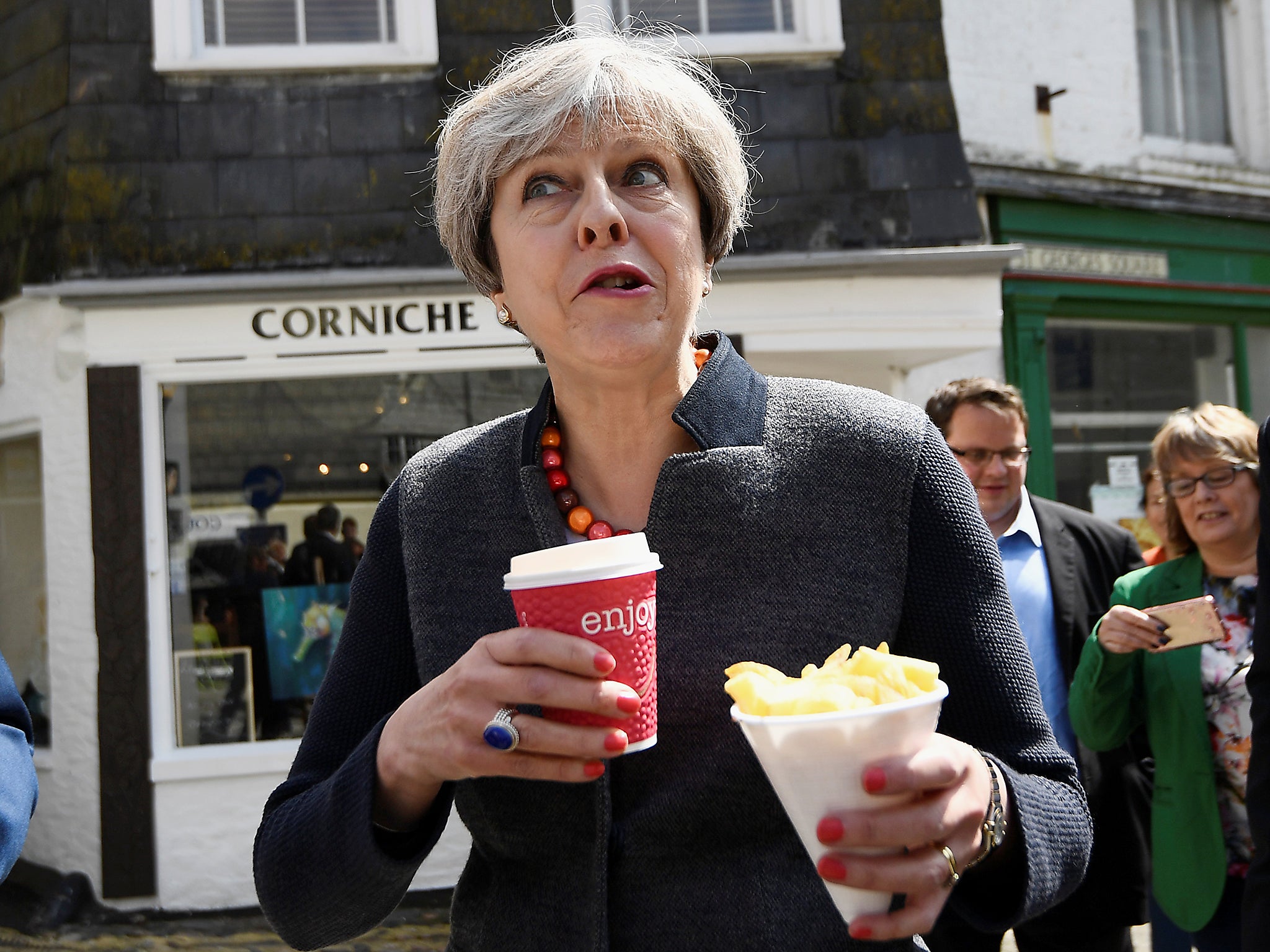 Britain's Prime Minister Theresa May enjoys some chips during a campaign stop in Mevagissey, Cornwall