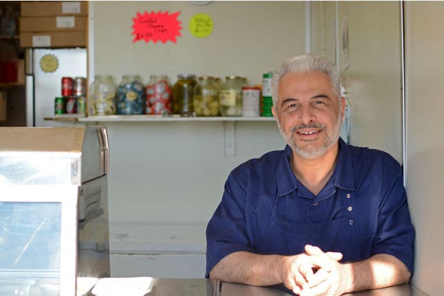 Kazem Hakimi at his fish and chip shop in East Oxford where he takes photos of his customers