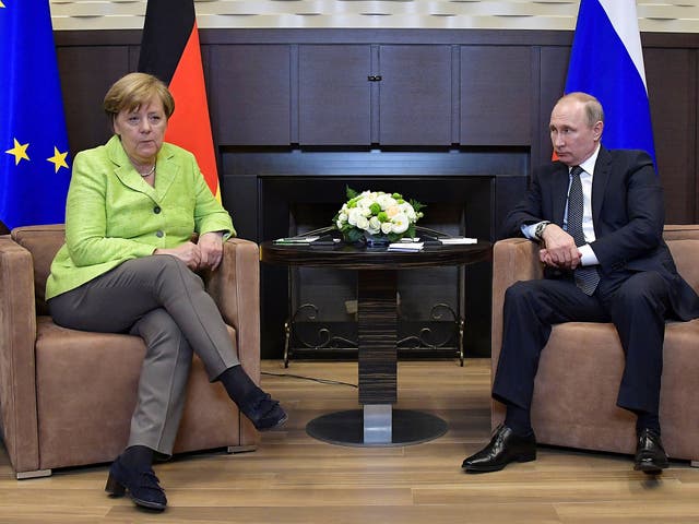 Russian President Vladimir Putin meets with German Chancellor Angela Merkel at the Bocharov Ruchei state residence in Sochi, Russia