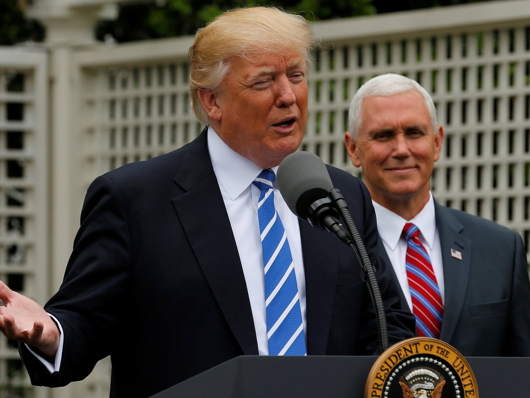 President Donald Trump, flanked by Vice President Mike Pence