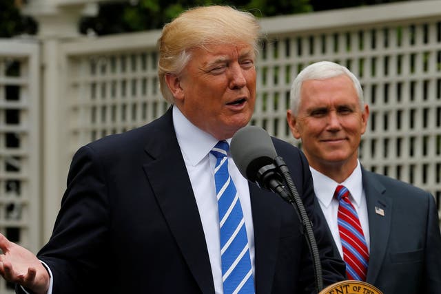 President Donald Trump, flanked by Vice President Mike Pence
