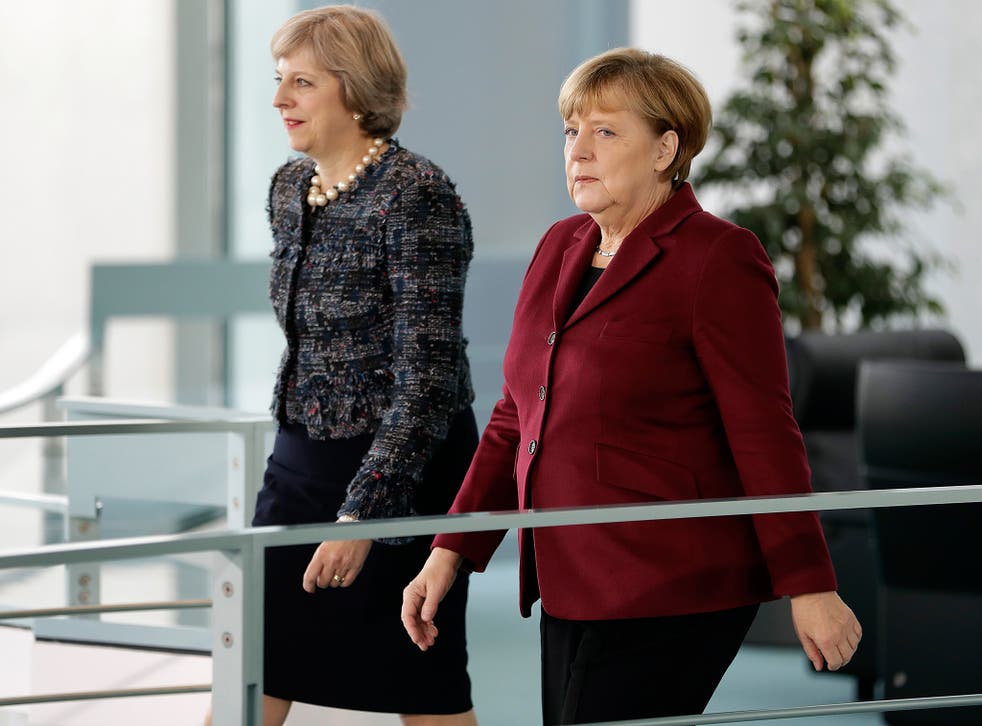 UK prime minister Theresa May walks beside the chancellor of Germany, Angela Merkel