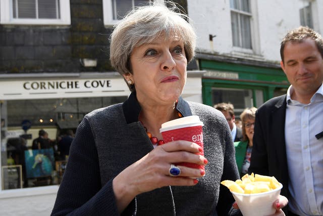 Prime Minister Theresa May having some chips while on a walkabout during a election campaign stop in Mevagissey, Cornwall