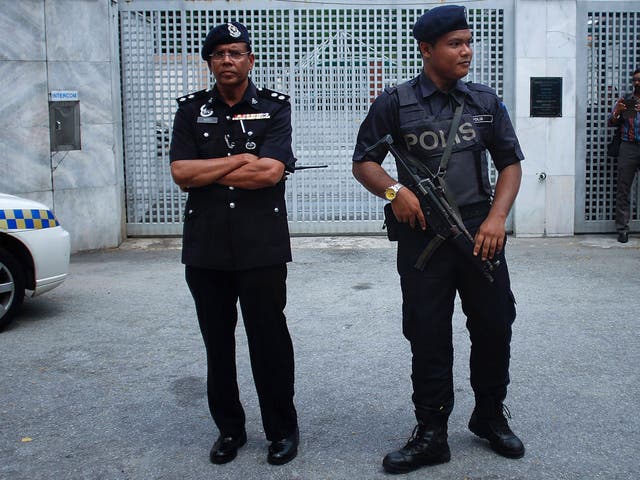 Malaysian police guard the entrance of Russian Federation embassy on July 22, 2014 in Kuala Lumpur, Malaysia. Malaysia Airlines flight MH17 was travelling from Amsterdam to Kuala Lumpur when it crashed killing all 298 on board including 80 children.