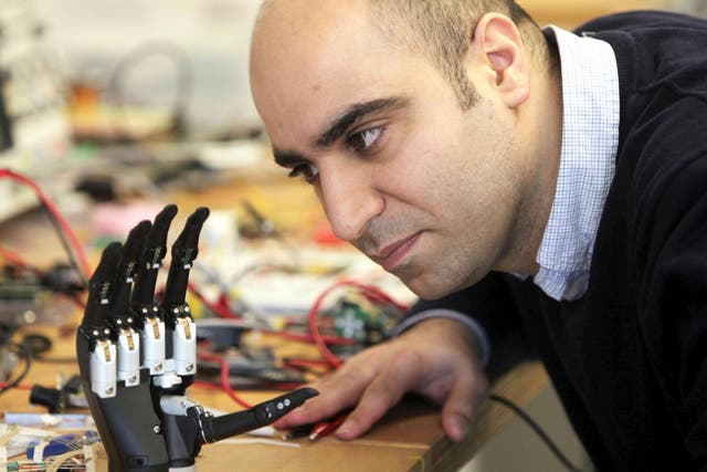 Dr Kianoush Nazarpour from Newcastle University's Biomedical Engineering department with a new bionic hand that 'sees' objects and instantly decides what kind of grip to adopt