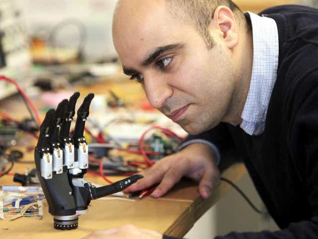 Dr Kianoush Nazarpour from Newcastle University's Biomedical Engineering department with a new bionic hand that 'sees' objects and instantly decides what kind of grip to adopt