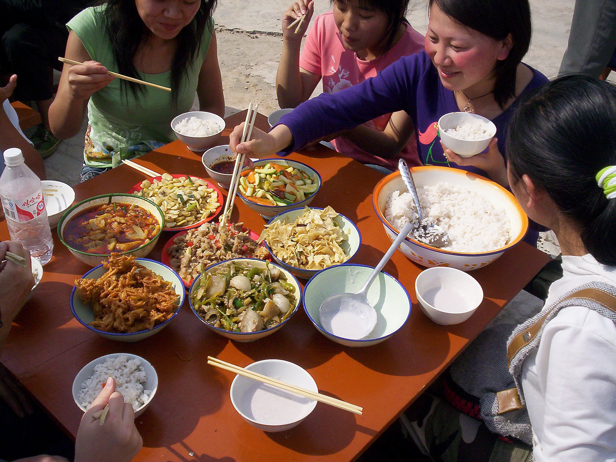 Jolly chopsticks: a family in China share a meal